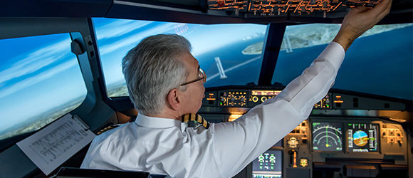 Over the shoulder view of a pilot flying a plane